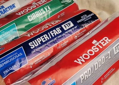 an assortment of packaged Wooster paint rollers